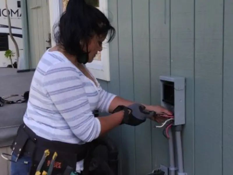 Licensed electrician wiring an exterior subpanel in Fairport Harbor
